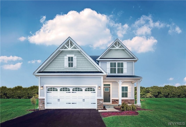 craftsman-style house featuring a front yard, an attached garage, covered porch, stone siding, and aphalt driveway