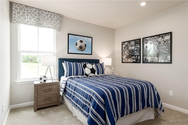 carpeted bedroom featuring baseboards