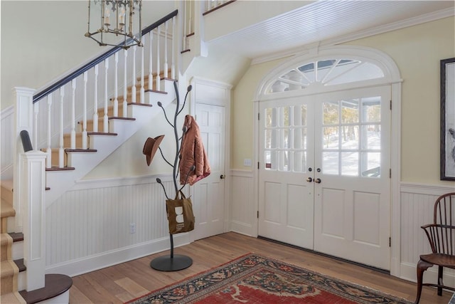 196 Wellington Ln, Springfield, NY 13326 - entrance foyer featuring wainscoting, stairs, wood finished floors, crown molding, and a chandelier