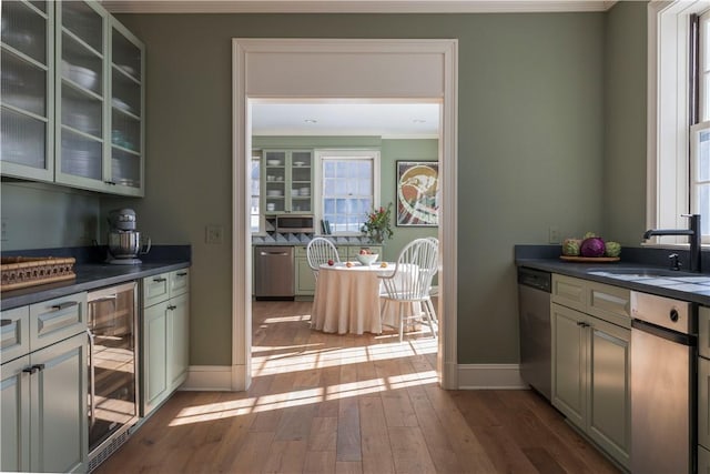 196 Wellington Ln, Springfield, NY 13326 - bar area with ornamental molding, stainless steel dishwasher, beverage cooler, and hardwood / wood-style flooring
