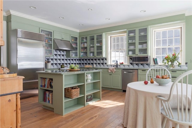 196 Wellington Ln, Springfield, NY 13326 - kitchen with stainless steel appliances, under cabinet range hood, green cabinetry, open shelves, and ornamental molding