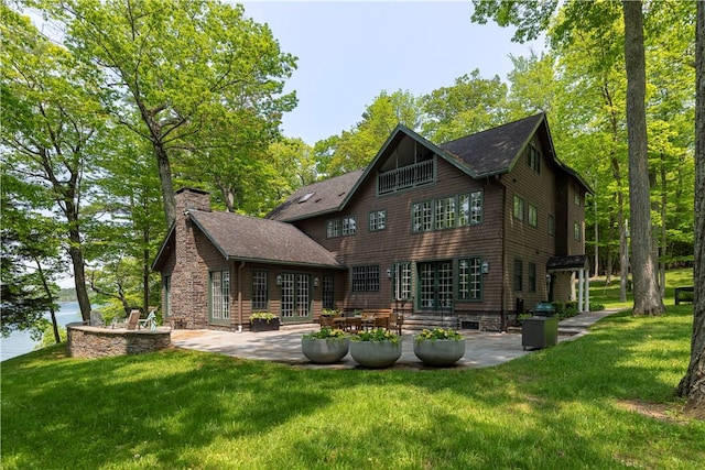196 Wellington Ln, Springfield, NY 13326 - back of property with a patio, a yard, and a chimney