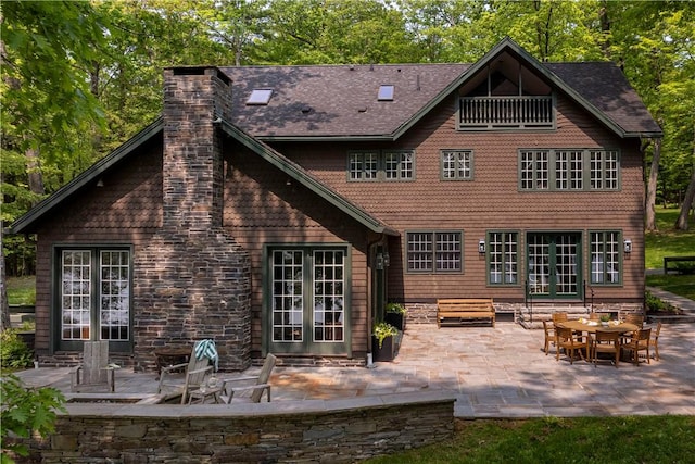 196 Wellington Ln, Springfield, NY 13326 - rear view of property with french doors, a patio, and a chimney