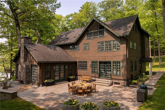 196 Wellington Ln, Springfield, NY 13326 - back of house with french doors, a patio, a chimney, and a shingled roof