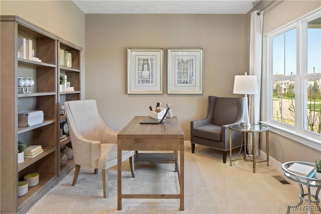 living area featuring visible vents, baseboards, and carpet floors
