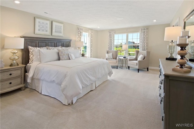 bedroom with recessed lighting, light colored carpet, visible vents, and baseboards