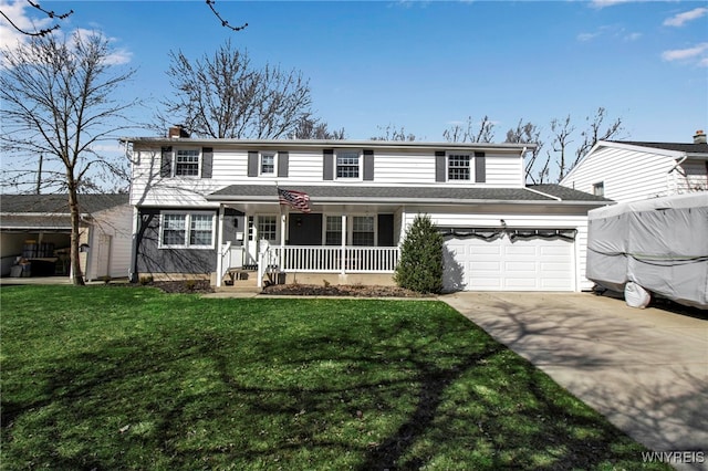traditional home with a porch, concrete driveway, a front yard, a chimney, and a garage