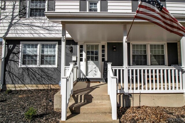 view of exterior entry with a porch