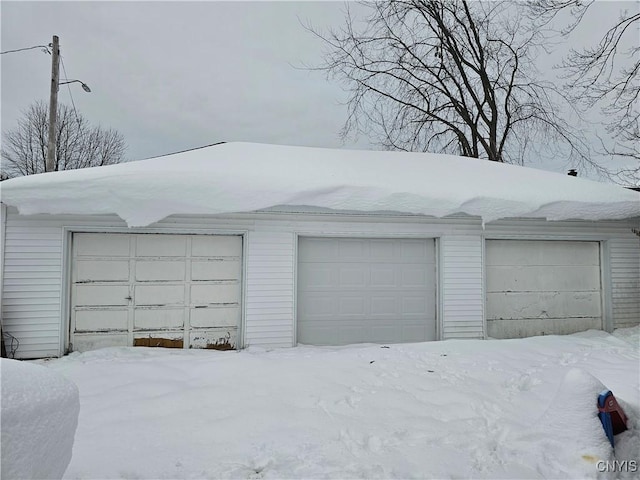 406 S George St, Rome-Inside, NY 13440 - snow covered garage featuring a garage