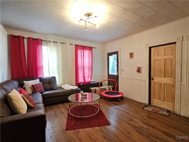 406 S George St, Rome-Inside, NY 13440 - living area with radiator, wood finished floors, and a wainscoted wall