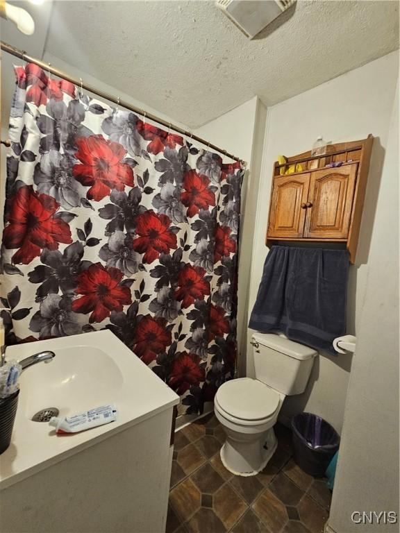 406 S George St, Rome-Inside, NY 13440 - full bathroom with a shower with shower curtain, a textured ceiling, vanity, and toilet