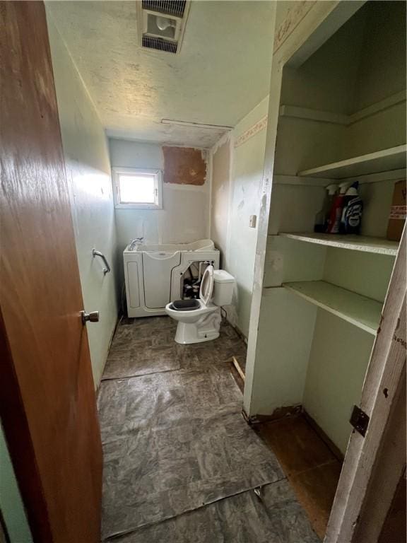 bathroom with visible vents and toilet