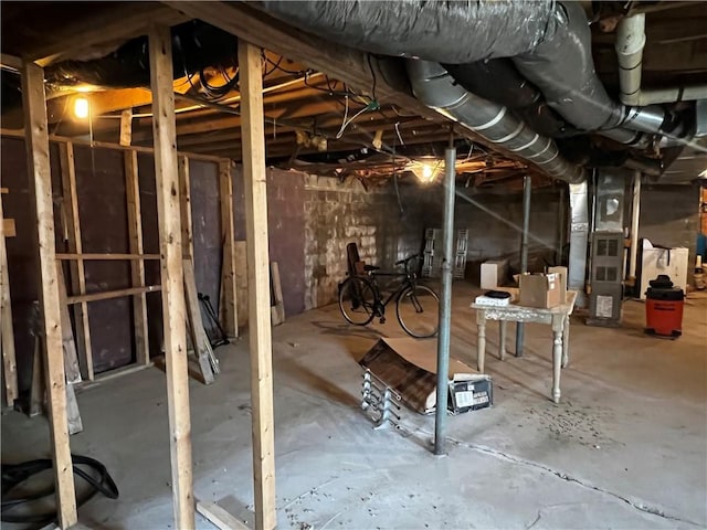 unfinished below grade area featuring heating unit