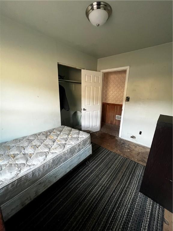 unfurnished bedroom featuring a closet and concrete flooring
