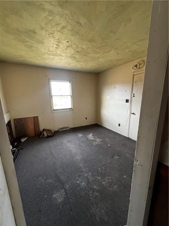 unfurnished room featuring visible vents