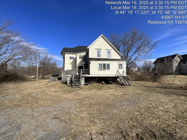 back of house featuring a deck