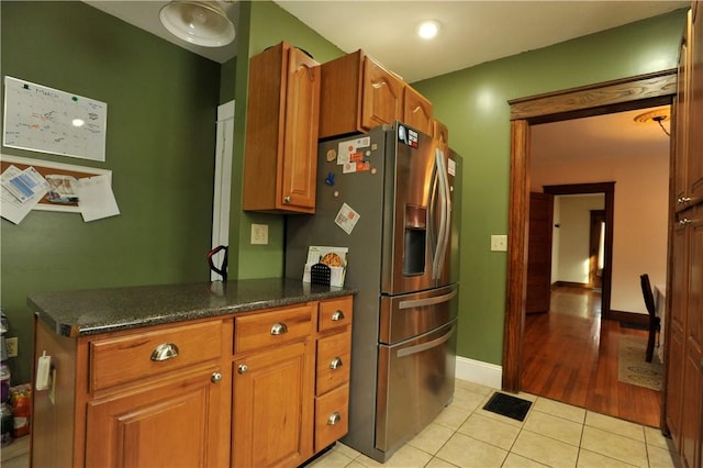 331 W Washington Ave, Elmira-City, NY 14901 - kitchen with light tile patterned floors, visible vents, brown cabinetry, and stainless steel fridge with ice dispenser