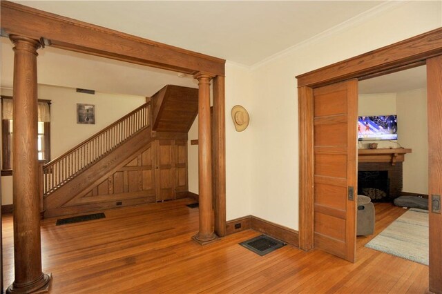 331 W Washington Ave, Elmira-City, NY 14901 - interior space featuring visible vents, ornamental molding, wood finished floors, a fireplace, and baseboards