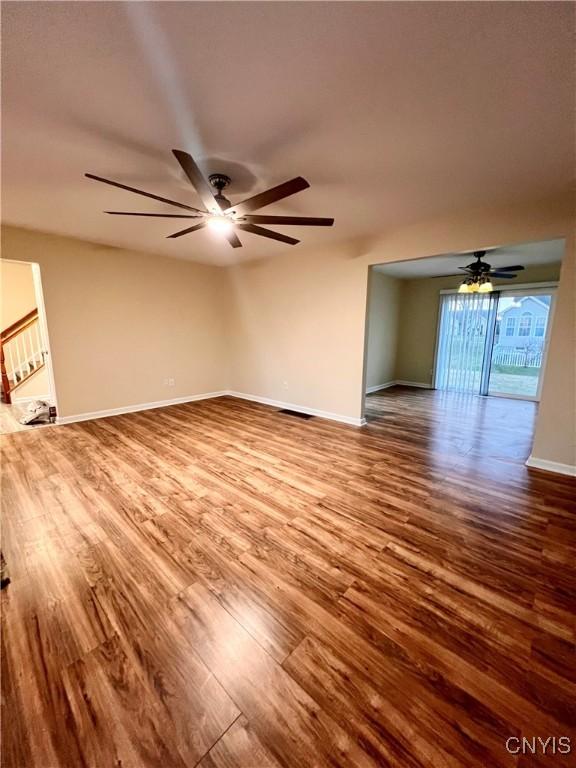 5499 Ravensthorpe, Clay, NY 13041 - unfurnished living room featuring wood finished floors, ceiling fan, and baseboards