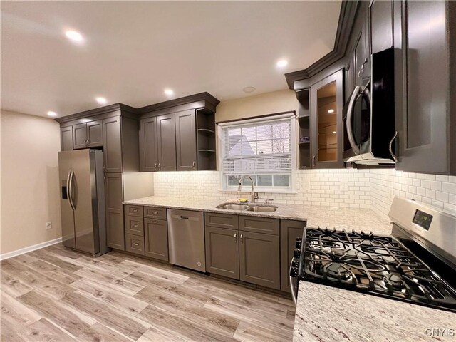 5499 Ravensthorpe, Clay, NY 13041 - kitchen featuring appliances with stainless steel finishes, a sink, open shelves, light stone counters, and tasteful backsplash