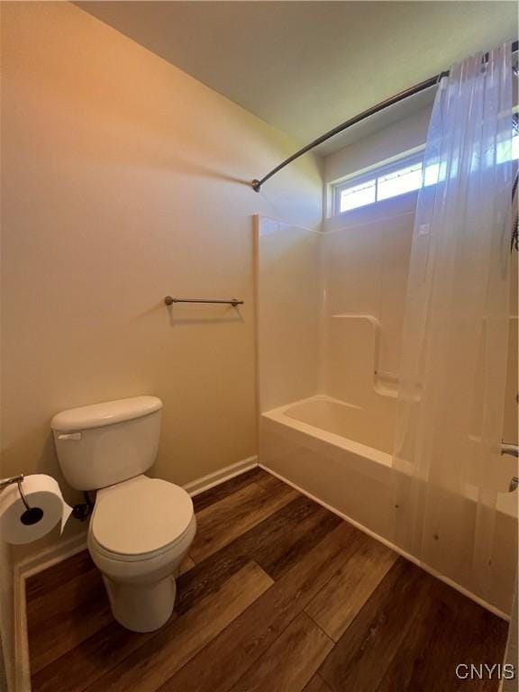 5499 Ravensthorpe, Clay, NY 13041 - bathroom with wood finished floors, toilet,  shower combination, and baseboards