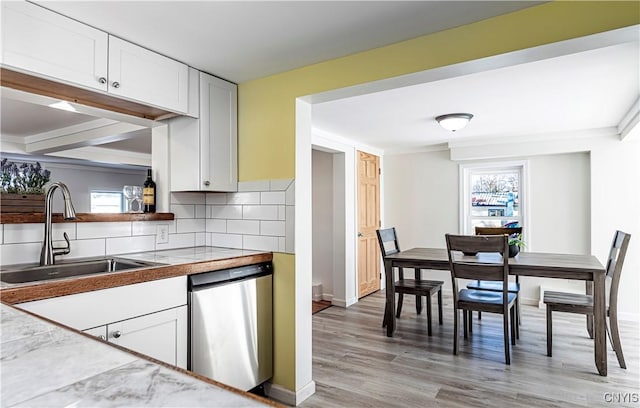 806 Clifford Ave, Vienna, NY 13157 - kitchen with backsplash, dishwasher, light wood-type flooring, white cabinetry, and a sink