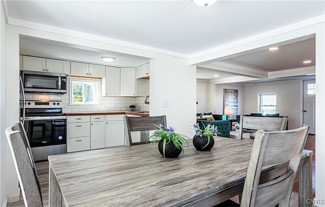 806 Clifford Ave, Vienna, NY 13157 - interior space featuring white cabinets, backsplash, and appliances with stainless steel finishes