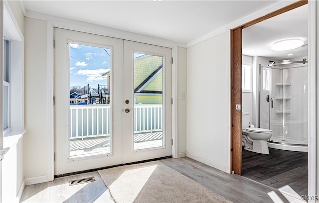 806 Clifford Ave, Vienna, NY 13157 - doorway with visible vents, french doors, baseboards, and wood finished floors