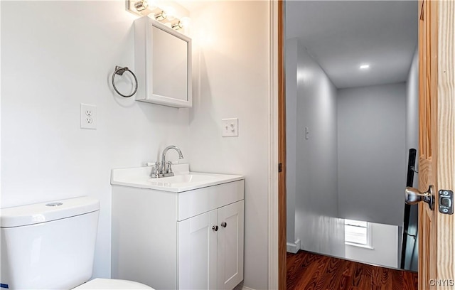 806 Clifford Ave, Vienna, NY 13157 - bathroom with vanity, toilet, and wood finished floors