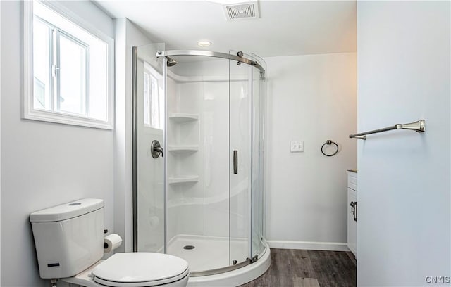 806 Clifford Ave, Vienna, NY 13157 - bathroom with visible vents, baseboards, toilet, a stall shower, and wood finished floors
