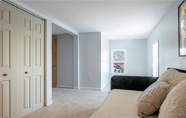 806 Clifford Ave, Vienna, NY 13157 - bedroom featuring carpet, baseboards, and a closet