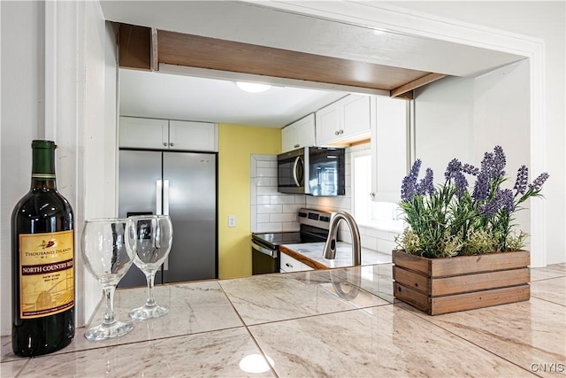806 Clifford Ave, Vienna, NY 13157 - kitchen with white cabinets, tasteful backsplash, and appliances with stainless steel finishes