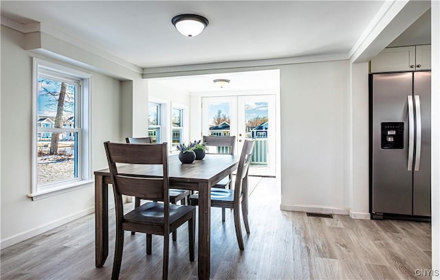806 Clifford Ave, Vienna, NY 13157 - dining room featuring visible vents, light wood-style floors, baseboards, and french doors