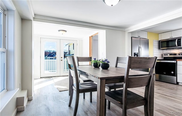 806 Clifford Ave, Vienna, NY 13157 - dining room featuring light wood-style flooring and french doors