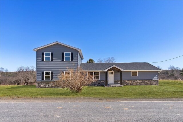 view of front of house featuring stone siding and a front lawn