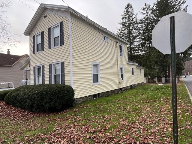 view of side of home with a lawn