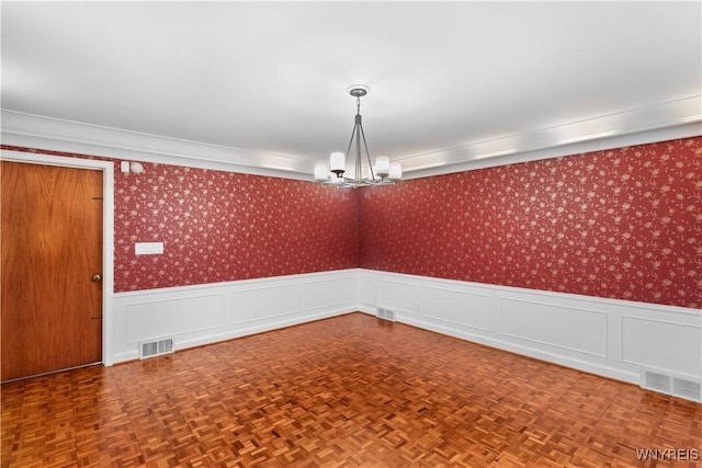 67 Nottingham Ter, Buffalo, NY 14216 - empty room with a chandelier, wainscoting, and wallpapered walls