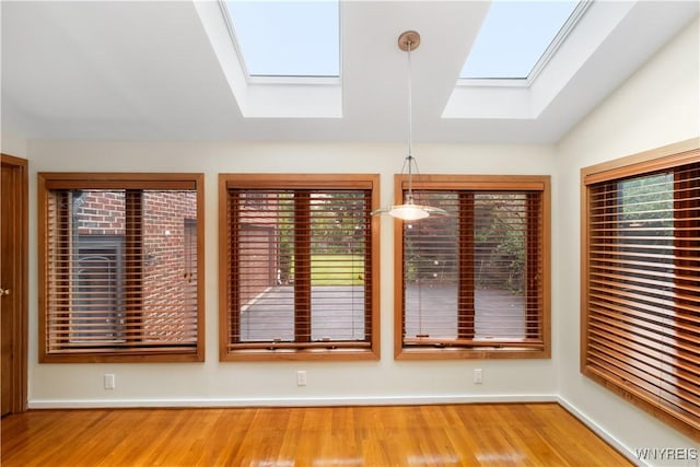 67 Nottingham Ter, Buffalo, NY 14216 - unfurnished dining area featuring a skylight, healthy amount of natural light, wood finished floors, and baseboards
