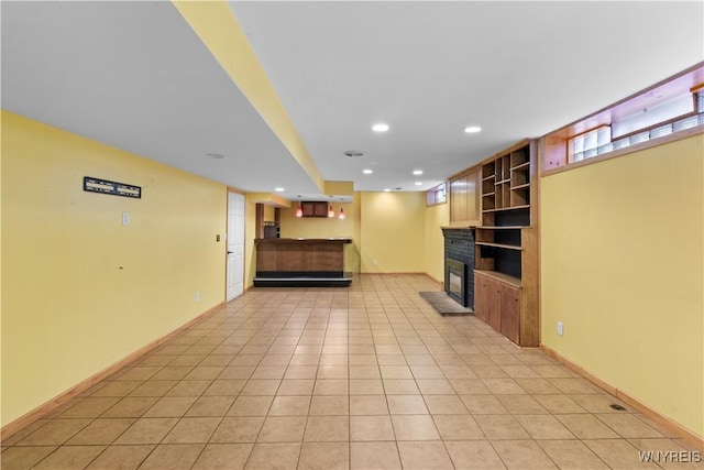 67 Nottingham Ter, Buffalo, NY 14216 - unfurnished living room with a glass covered fireplace, recessed lighting, built in shelves, baseboards, and light tile patterned flooring