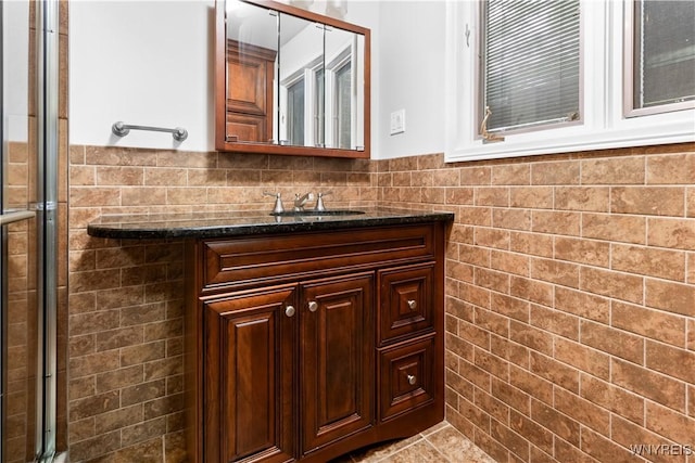 67 Nottingham Ter, Buffalo, NY 14216 - full bathroom featuring tile walls, vanity, a tile shower, and wainscoting