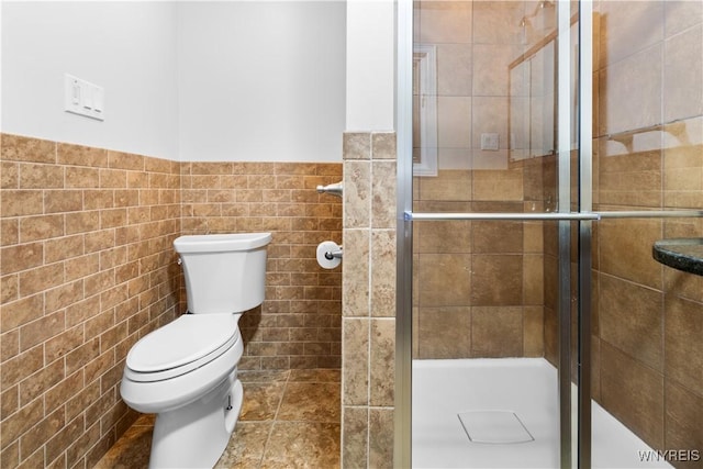 67 Nottingham Ter, Buffalo, NY 14216 - bathroom featuring tile walls, a stall shower, toilet, and wainscoting