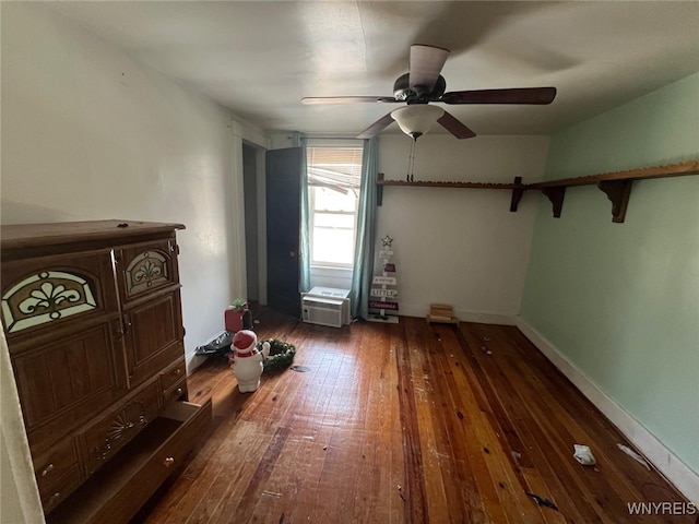 unfurnished bedroom with a ceiling fan, baseboards, and hardwood / wood-style floors