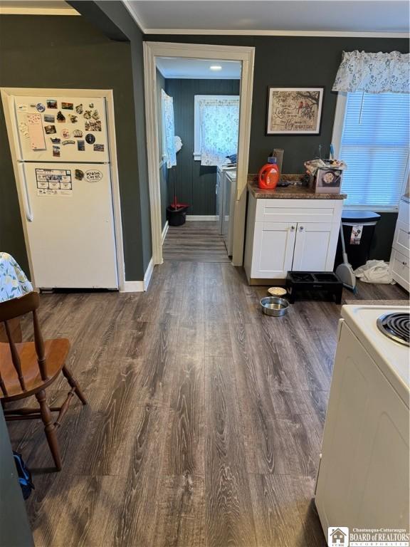 48 Thayer St, Jamestown, NY 14701 - interior space featuring white cabinetry, stove, wood finished floors, and freestanding refrigerator