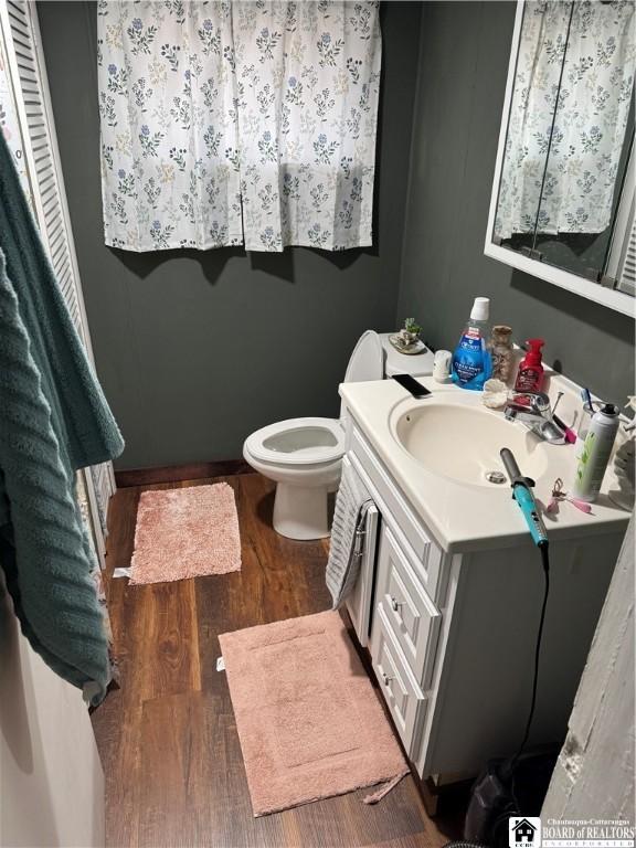 48 Thayer St, Jamestown, NY 14701 - half bathroom featuring toilet, vanity, and wood finished floors