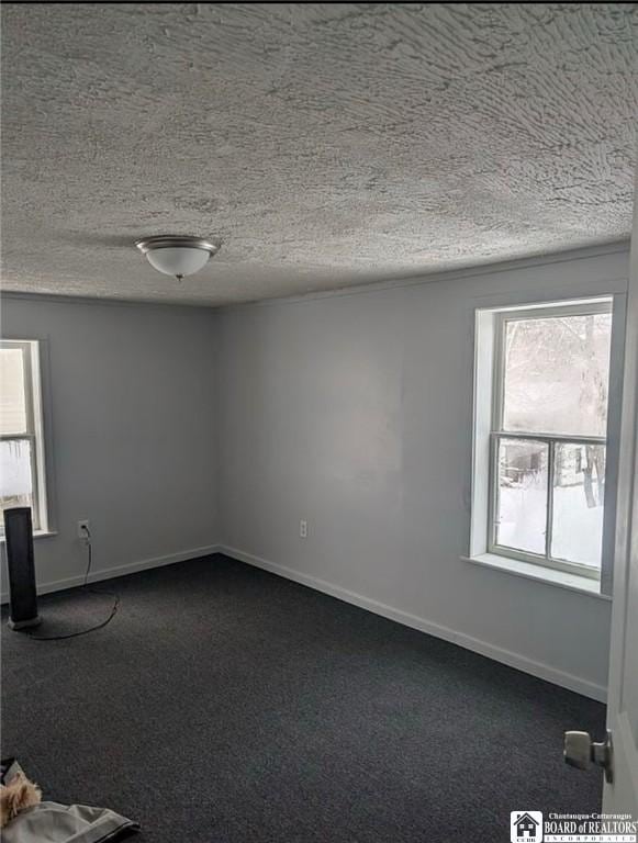 48 Thayer St, Jamestown, NY 14701 - unfurnished room featuring dark carpet, a textured ceiling, and baseboards