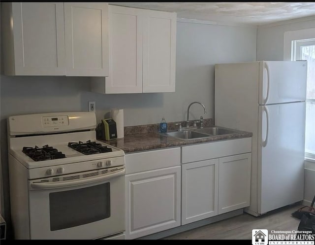 48 Thayer St, Jamestown, NY 14701 - kitchen featuring a sink, dark countertops, white appliances, light wood-style floors, and white cabinets