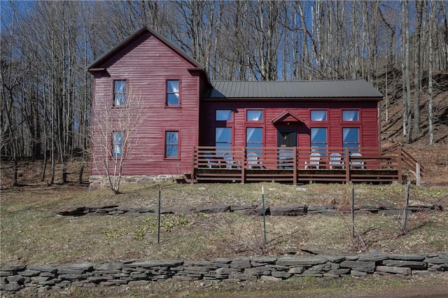 view of front of property with metal roof and a wooden deck