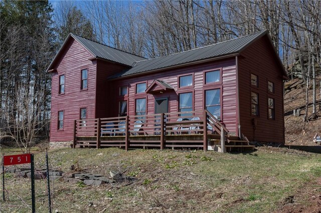 view of front of home featuring a deck and metal roof