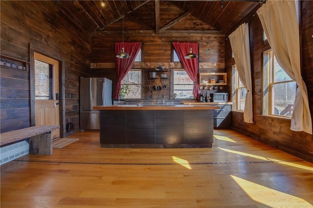 bar featuring wooden walls, wooden ceiling, and stainless steel appliances