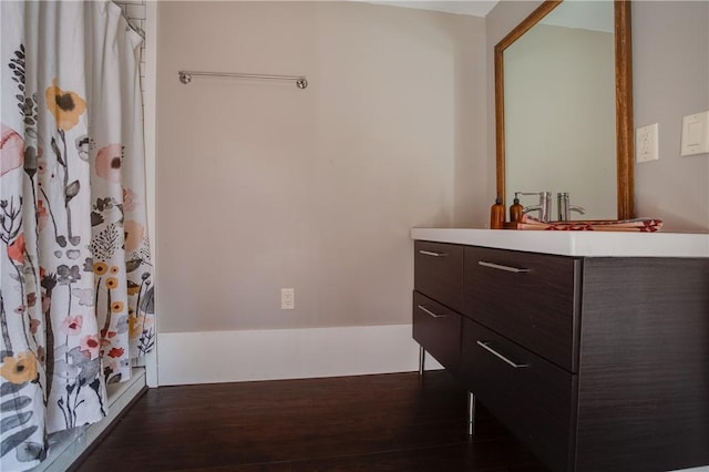 bathroom with wood finished floors and vanity